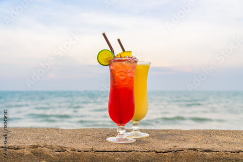 Iced cocktails drinking glass with sea and beach