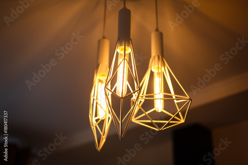 Industrial pendant lamps against rough wall loft interior edison bulbs