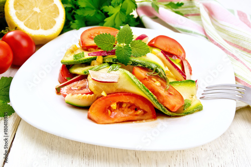 Salad with zucchini and tomato on light board