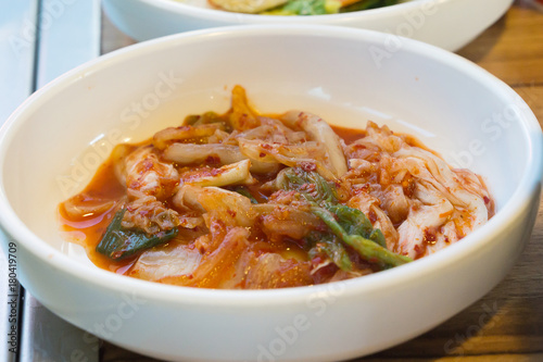 Gimchi in the bowl and put on the wooden table. Thai is tradition food and side dish for korean food.