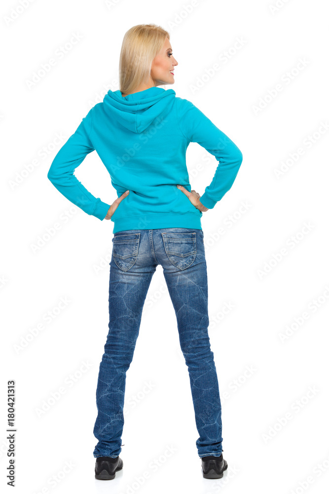 Fototapeta premium Rear View Of Woman In Jeans And Turquoise Hoodie