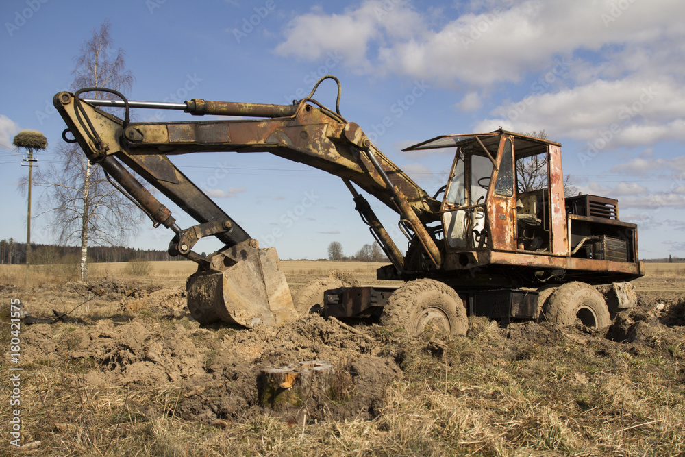 The image of the tractor stuck in the mud The image of the tractor stuck in the mud