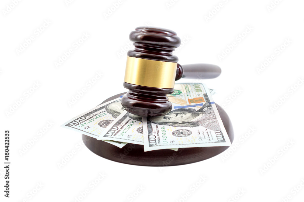 Judge's gavel with stand and money on white.