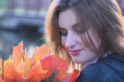 Young romantic beautiful Russian girl Maria in the autumn park dreams of love photo