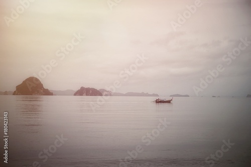 Beach scenery with the islands boat in the cloudy day with the lonely mood and copy space for text design