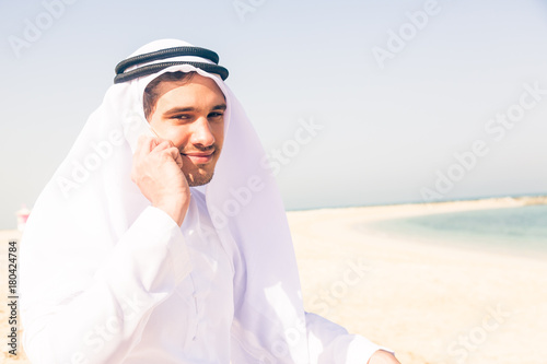 Young Arabian Man Sitting At The Beach © nullplus