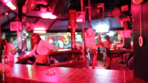 Blurred backgound with sexy Go Go bar with thai girls in Thailand. open-air bar girls dancing to entertain tourists on the counter or with sexy pole lap dance.