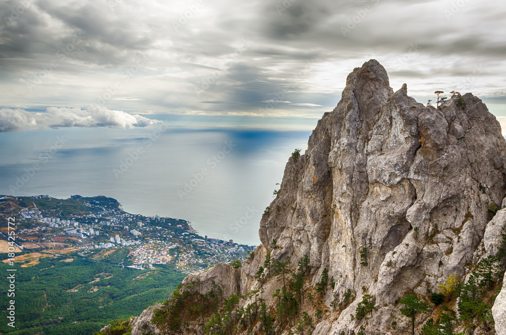 Beautiful landscape. View from the Ai-Petri mountain to the forest, the sea and the city of Yalta on a cloudy autumn day.