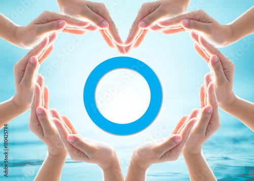 World diabetes day concept with blue circle symbolic logo among protective heart-shape hands for diabetic disease prevention screening awareness campaign