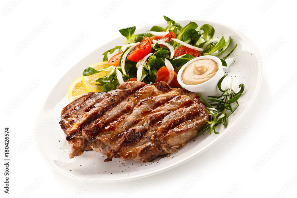 Grilled steak with vegetables on white background Grilled steak with vegetables on white background