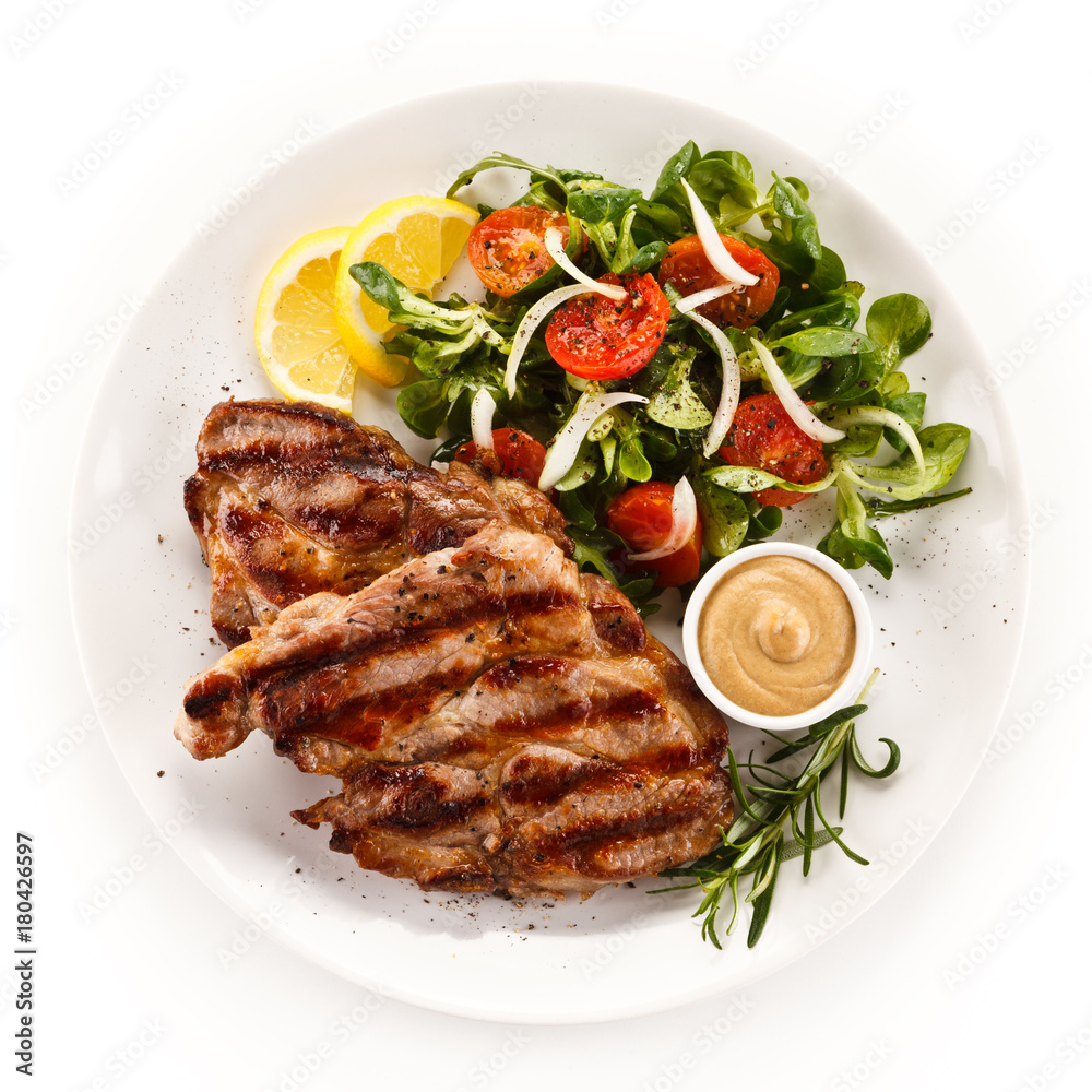 Grilled steak with vegetables on white background Grilled steak with vegetables on white background