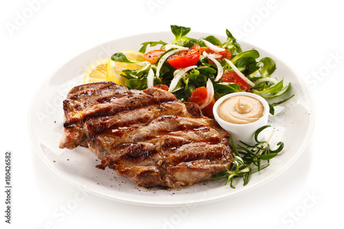 Grilled steak with vegetables on white background