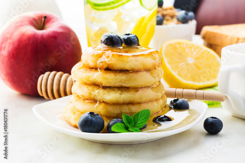 Healthy breakfast with homemade pancakes with honey and fruits