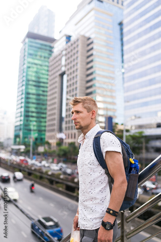 Young men, boy with backpack in Downtown. Traveler in Bangkok. European guy