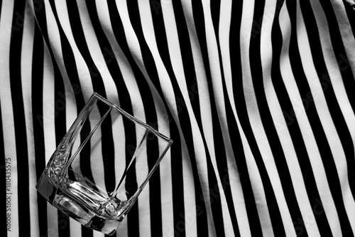 Abstract geometric black and white background with a glass of old fashioned