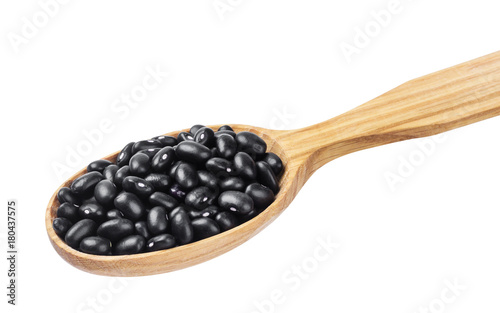Black beans in wooden spoon isolated on white background
