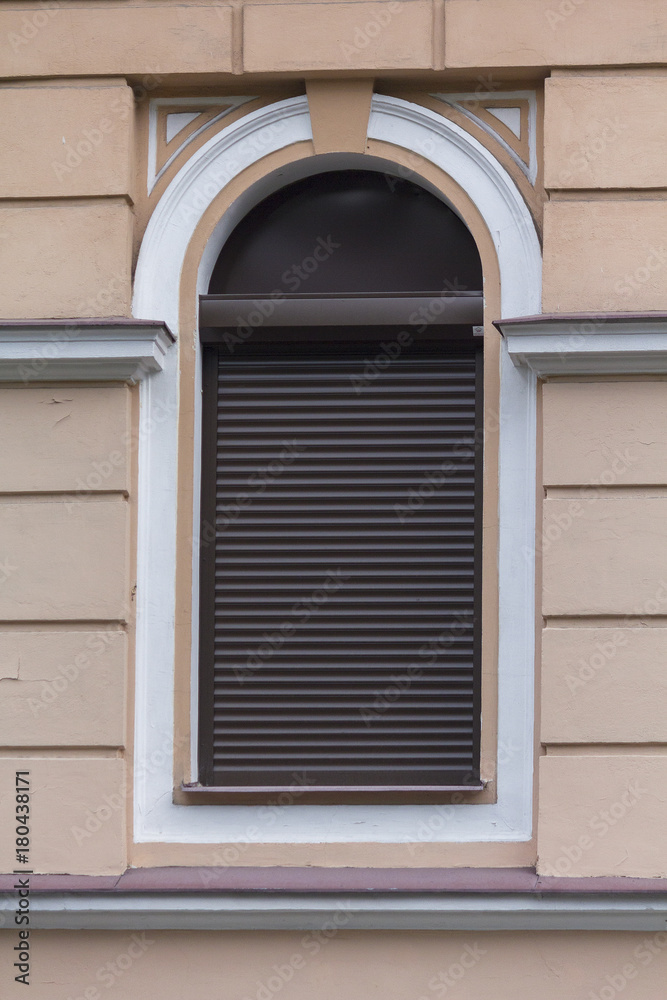 Arched window in classical style with jalousie. Architecture Arched window in classical style with jalousie. Architecture