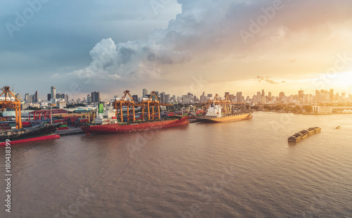 Container ship in import export and business logistic, By crane, Trade Port, Shipping cargo to harbor, International transportation, Business logistics concept, Aerial view from drone.