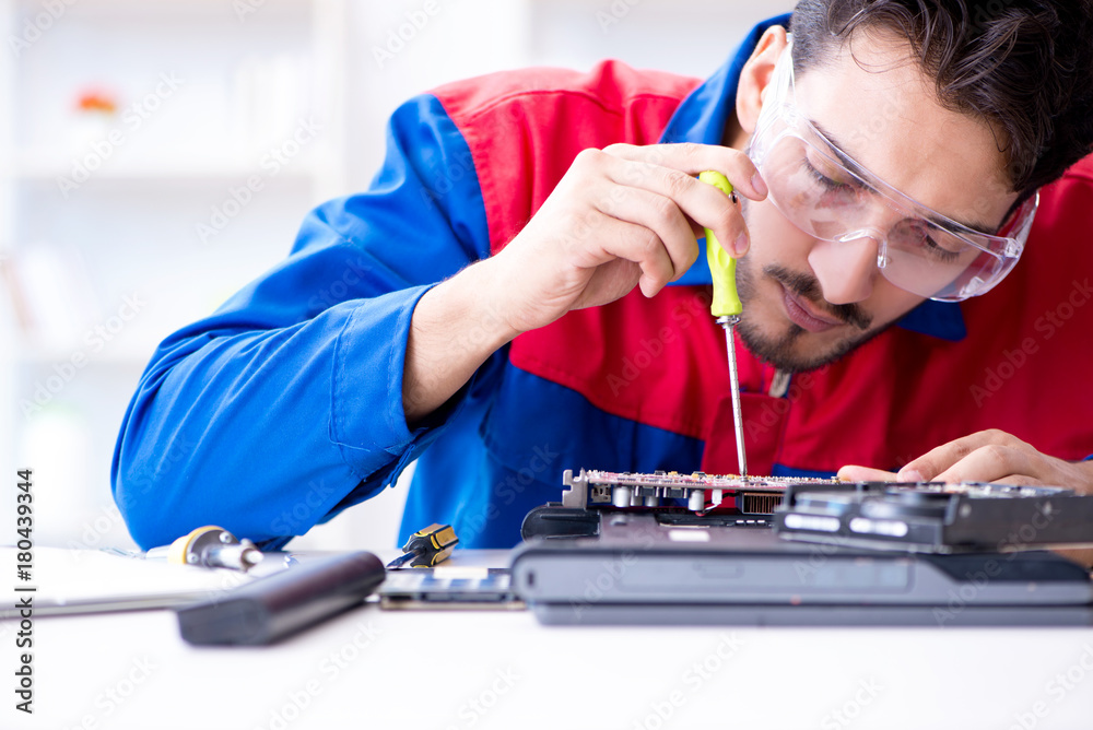 Repairman working in technical support fixing computer laptop tr Repairman working in technical support fixing computer laptop tr