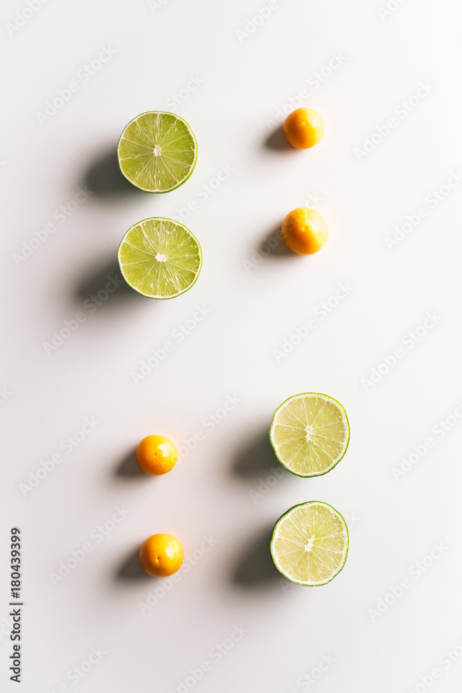 Fresh tropical fruits symmetrically placed on minimal white background. Diet and healthy nutrition concept. Top view.