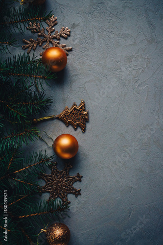 Christmas background on a concrete table with firs and toys