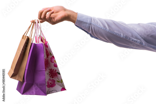 Hand holding shopping bags with christmas shopping on white back