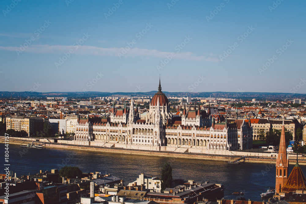 Evening sun on the facade of the Parliament building across Danube river, Budapest Hungary.