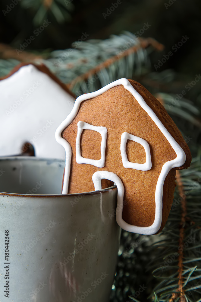 New Year gingerbreads with a cup of hot chocolate. Christmas tree and toys. Dark background.