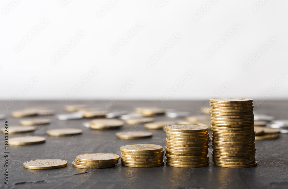 Increasing columns of gold coins on table Increasing columns of gold coins on table