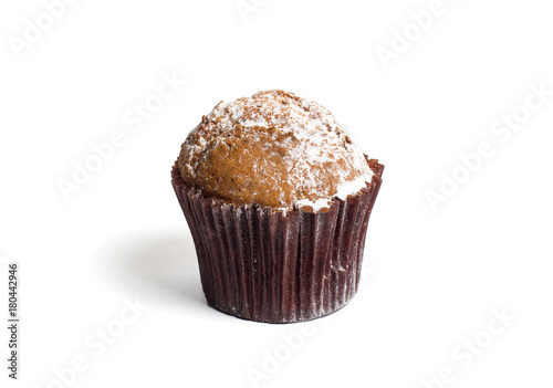 Chocolate chip muffin cup cake with powdered sugar closeup isolated on white background.
