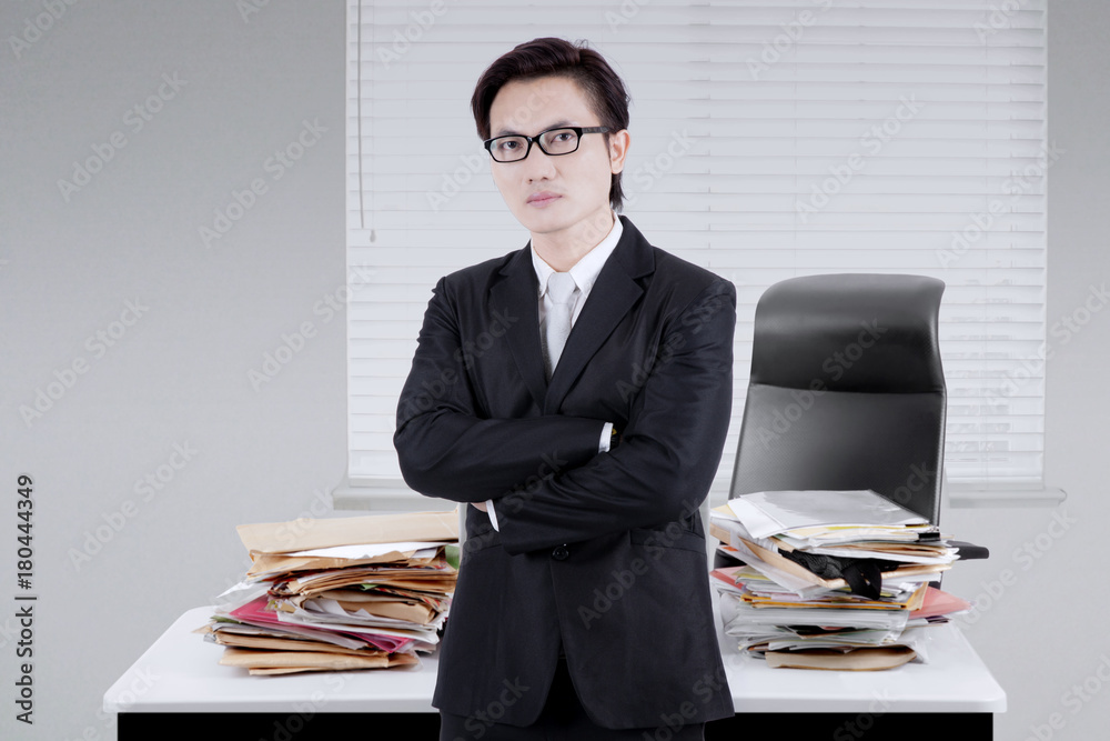 Male manager looks confident in the office Male manager looks confident in the office