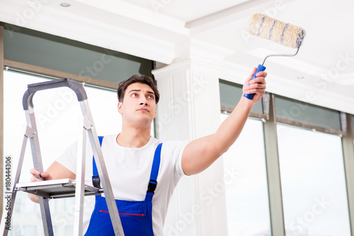 Painter repairman working at construction site