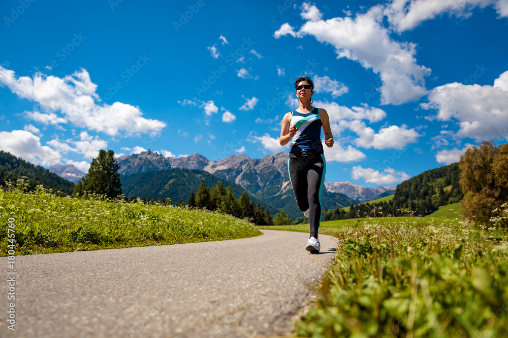 Woman jogging outdoors. Italy Dolomites Alps Woman jogging outdoors. Italy Dolomites Alps