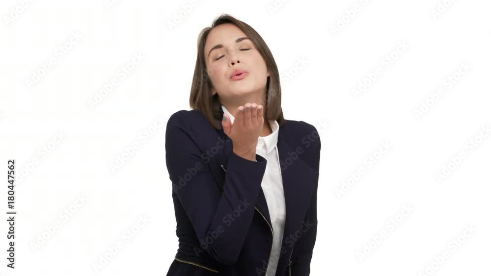 horizontal portrait of cheerful businesswoman in formal playfully posing on camera giving air kiss and winking being flirty smiling over white background in studio. Concept of emotions horizontal portrait of cheerful businesswoman in formal playfully posing on camera giving air kiss and winking being flirty smiling over white background in studio. Concept of emotions