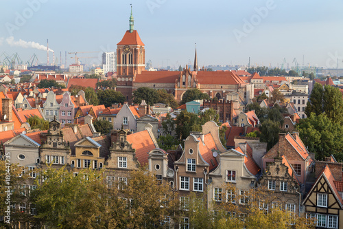 Old residential buildings at the Main Town (Old Town) and St. Cathrine's Church in Gdansk, Poland, viewed from above in the morning.