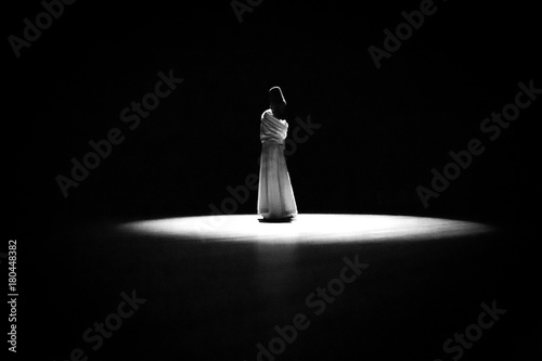 Φωτογραφία the image of a whirling Dervish in the darkness