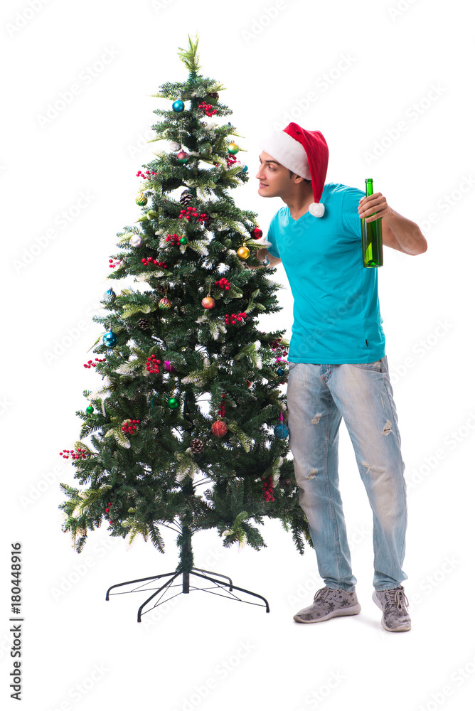 Young man decorating christmas tree isolated on white Young man decorating christmas tree isolated on white