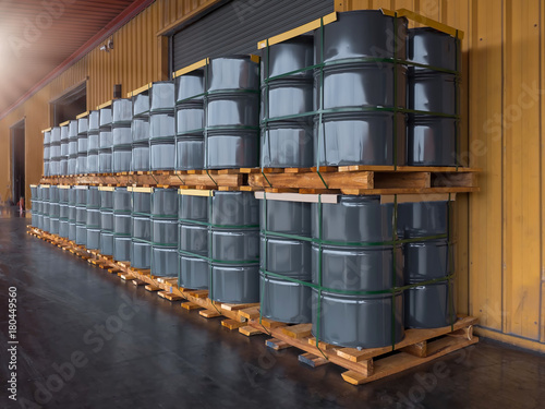 Gray oil drums on pallet stacking  in front of  industrail warehouse