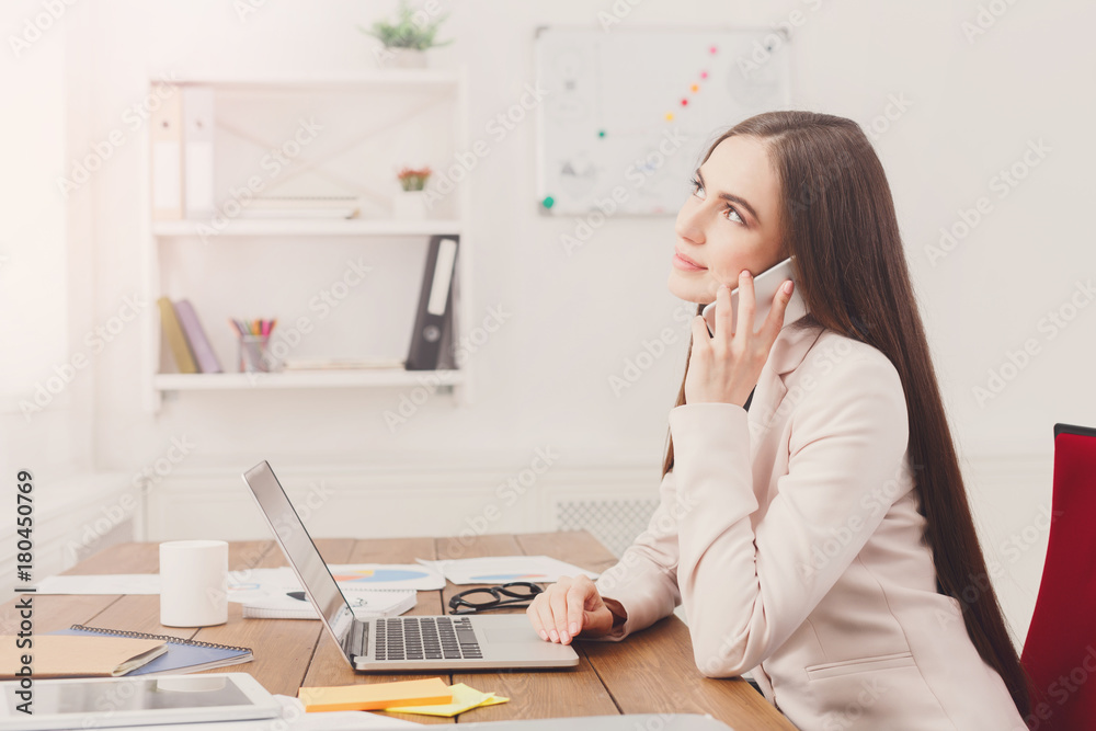 Serious business woman at work talking on phone Serious business woman at work talking on phone