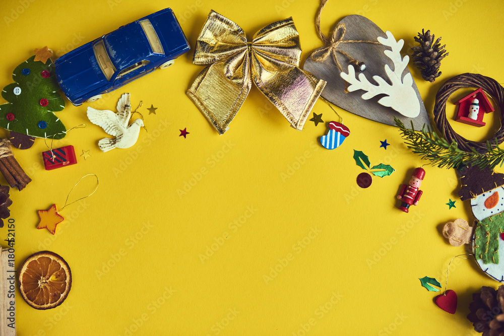 A lot of Christmas decorations and toys  on yellow background. Space for text. Design mockup