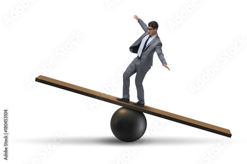 Obraz na plátně Businessman balancing on seesaw in uncertainty concept