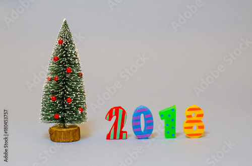 Christmas tree with 2018 numbers on gray background