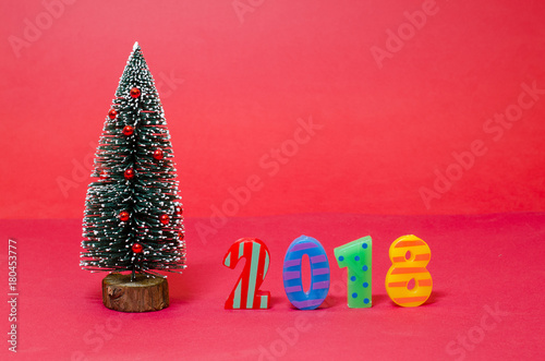 Christmas tree with 2018 numbers on red background 