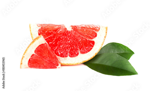 Grapefruit piece isolated on white background. Fresh fruit. With clipping path. Fresh grapefruit with green leaves isolated. photo