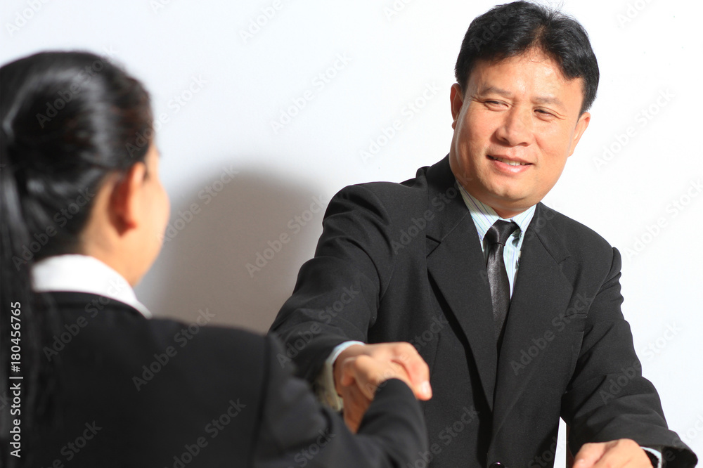 Asian business handshake reach agreement sign contract in office Asian business handshake reach agreement sign contract in office
