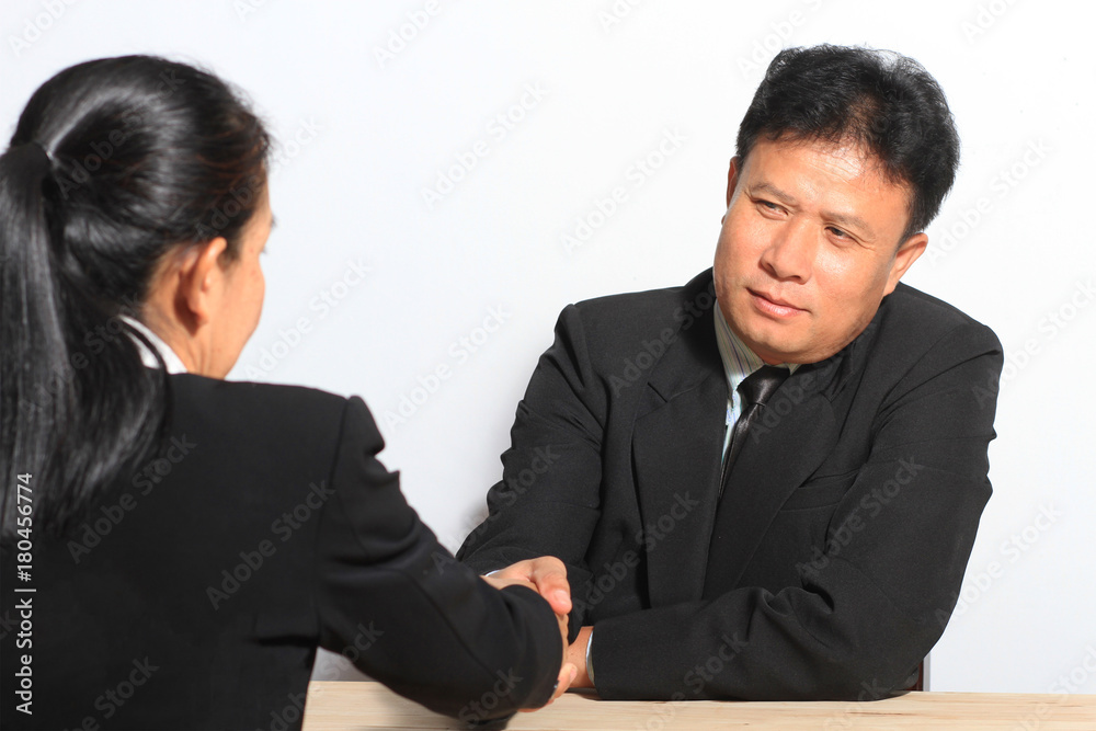 Asian business boss and secretary handshake meeting in office Asian business boss and secretary handshake meeting in office