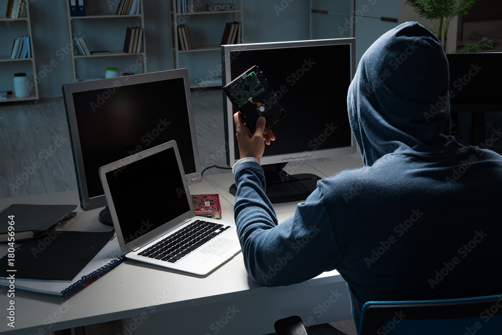 Hacker hacking computer at night Hacker hacking computer at night
