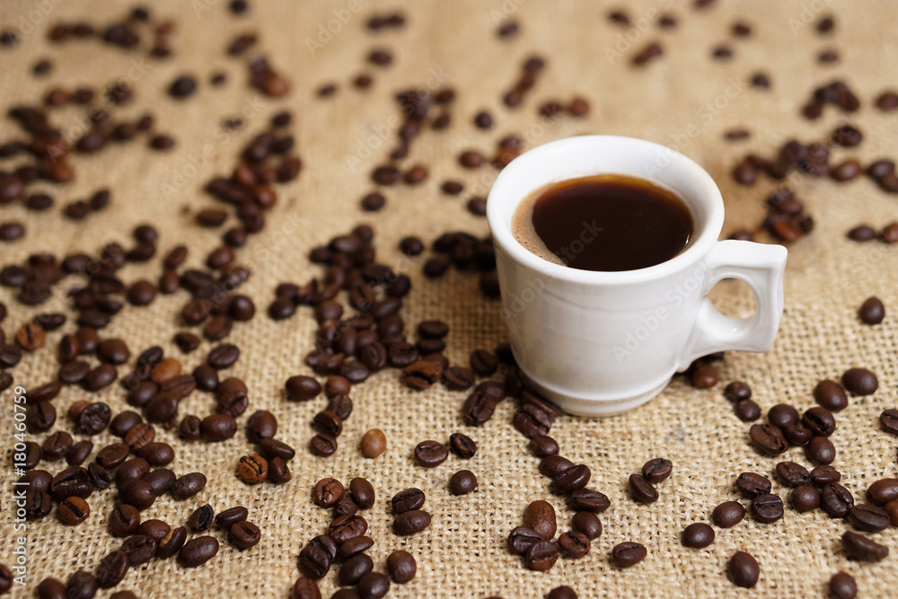 Cup of coffee on sackcloth with coffee beans Cup of coffee on sackcloth with coffee beans