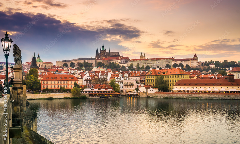 Prague Castle and Charles Bridge at sunset, Prague, Czech Republic in the fall. Lanterns and sculptures on the Charles Bridge