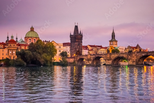 Manes bridge in Prague, Czech Republic at sunset. Ducks and swans on the river